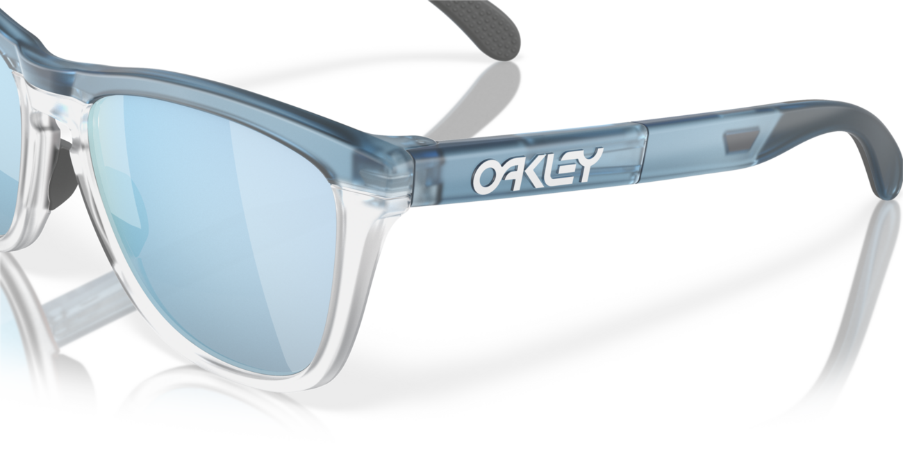 Oakley FROGSKINS RANGE mit Rahmen Trans Stonewash/Clear und mit Dias Prizm Deep Water Polarized 55